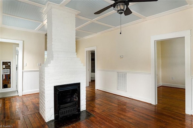 unfurnished living room featuring ornamental molding, a brick fireplace, ceiling fan, and dark hardwood / wood-style flooring