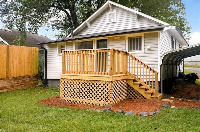 back of house with a deck and a yard