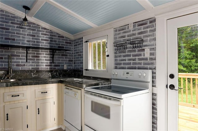 kitchen with lofted ceiling, white appliances, plenty of natural light, and ornamental molding