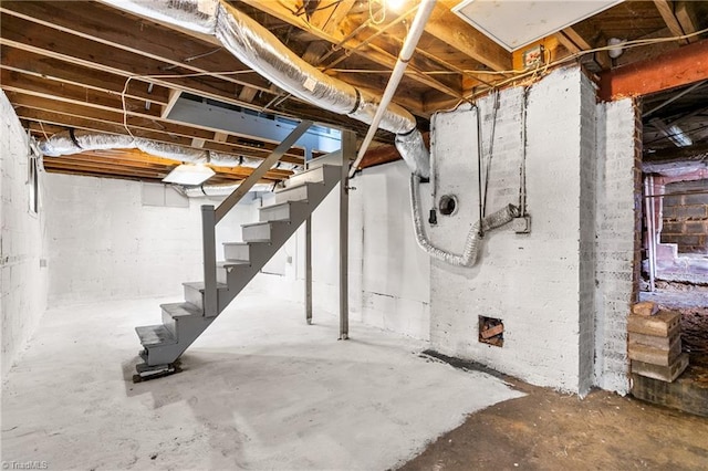 unfinished basement featuring stairs