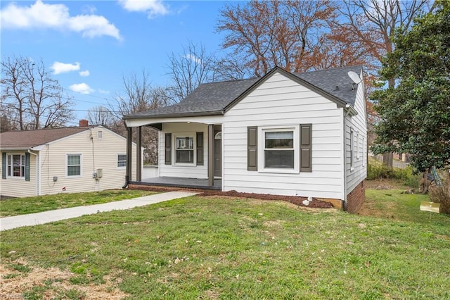 bungalow-style home with a porch, a shingled roof, and a front yard