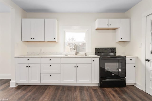 kitchen with black electric range oven, a sink, white cabinetry, baseboards, and dark wood-style flooring