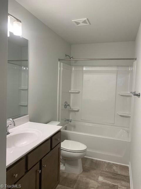 full bathroom featuring vanity, toilet, and shower / tub combination