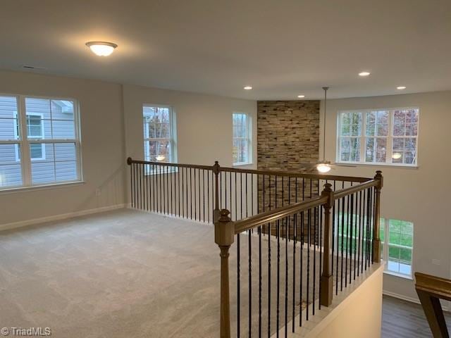 hallway featuring plenty of natural light and carpet floors