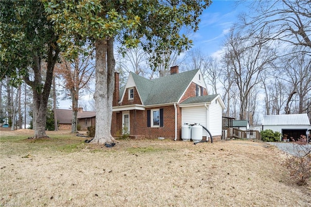 view of side of home with a garage and a lawn