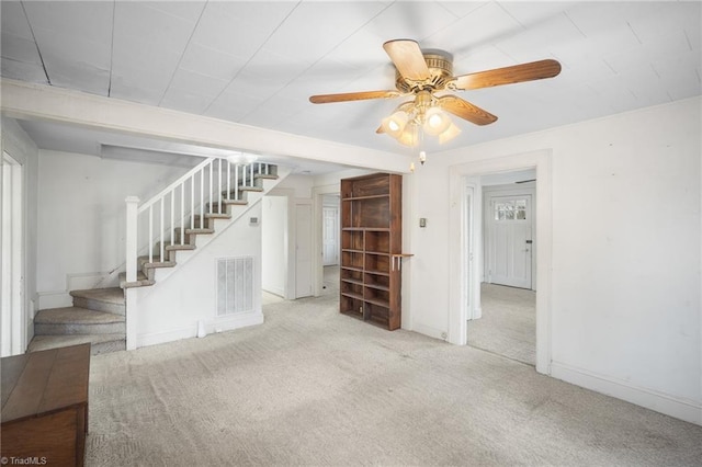 unfurnished living room featuring light colored carpet and ceiling fan