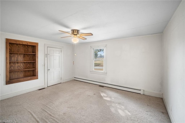 carpeted spare room featuring ceiling fan and a baseboard radiator