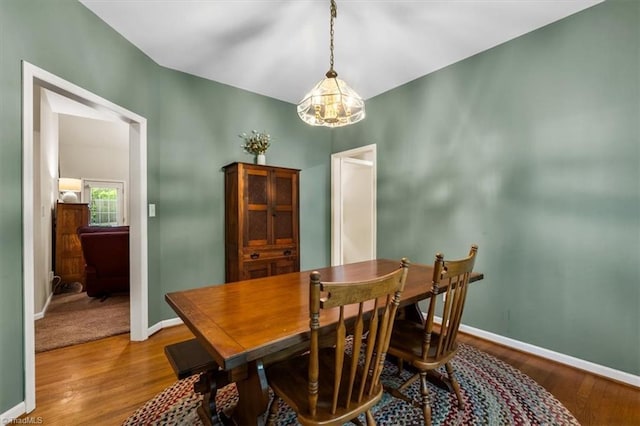dining room with baseboards and wood finished floors