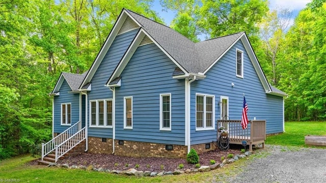 exterior space featuring crawl space, roof with shingles, and a deck