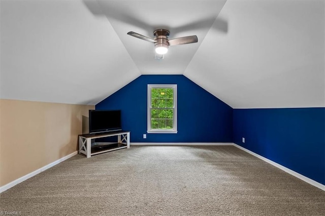 additional living space with carpet floors, ceiling fan, vaulted ceiling, and baseboards