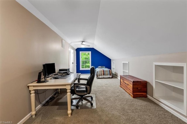 carpeted home office featuring baseboards, vaulted ceiling, and visible vents