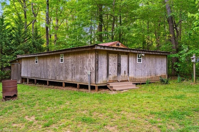 back of house with a yard and metal roof