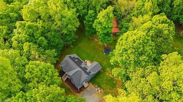 birds eye view of property with a wooded view