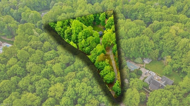 drone / aerial view featuring a wooded view