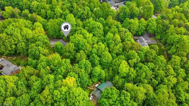 birds eye view of property with a wooded view