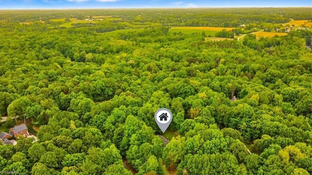 birds eye view of property featuring a wooded view