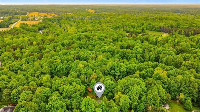 birds eye view of property with a view of trees