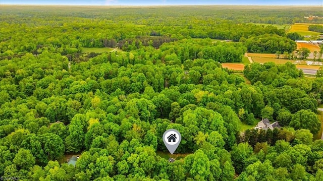 drone / aerial view featuring a wooded view