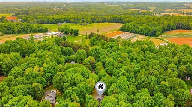 drone / aerial view featuring a wooded view