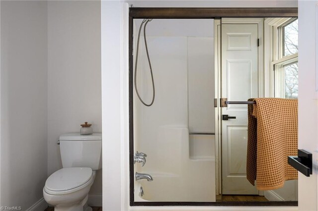 bathroom with shower / tub combination and toilet