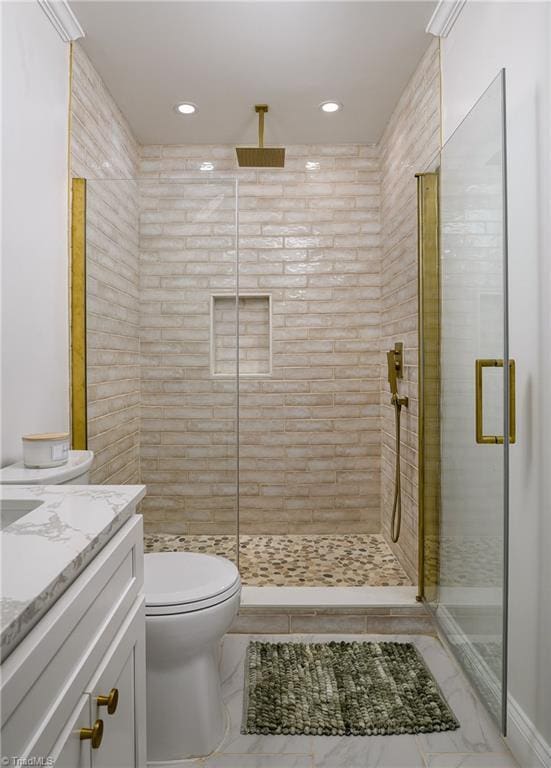 bathroom featuring an enclosed shower, vanity, and toilet