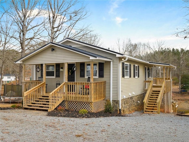 view of front of house with a trampoline and a porch