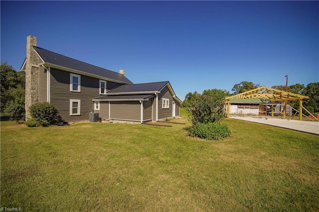 exterior space with cooling unit and a lawn