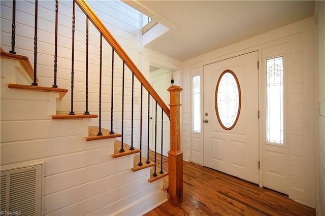 entryway featuring hardwood / wood-style floors and a skylight