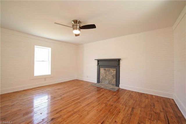 unfurnished living room with hardwood / wood-style floors and ceiling fan