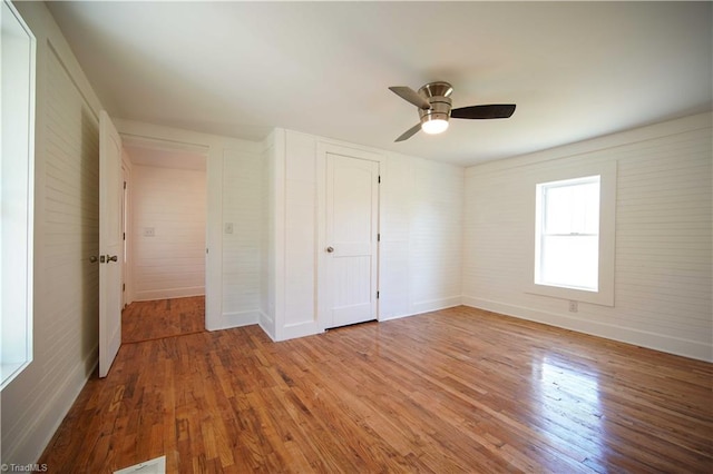 unfurnished bedroom with ceiling fan and hardwood / wood-style floors