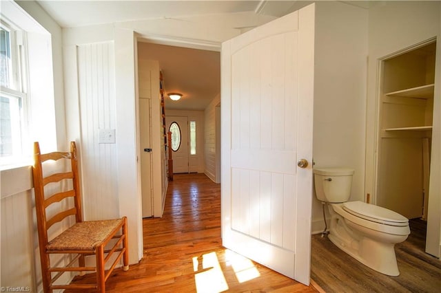 hallway with hardwood / wood-style flooring