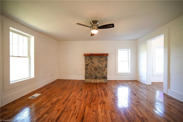 unfurnished living room with ceiling fan, hardwood / wood-style flooring, and a fireplace