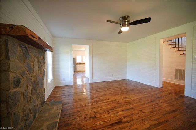 unfurnished living room with ceiling fan and dark hardwood / wood-style flooring