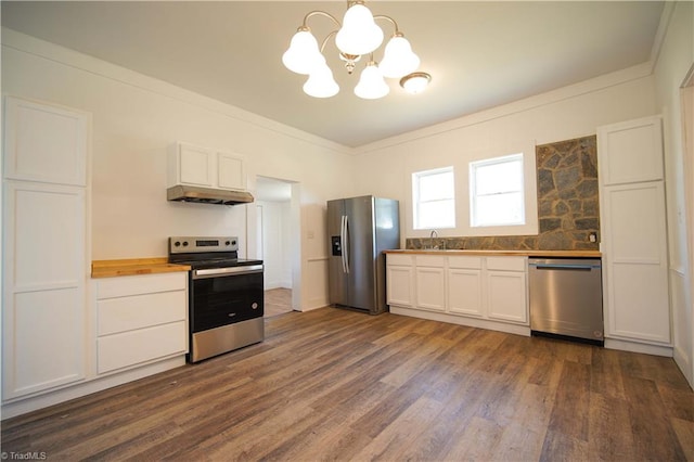 kitchen featuring dark hardwood / wood-style floors, stainless steel appliances, wood counters, decorative light fixtures, and white cabinets