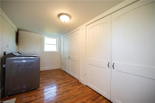 laundry area featuring dark wood-type flooring and washing machine and clothes dryer