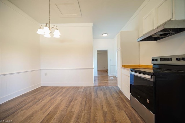 kitchen with white cabinetry, hardwood / wood-style flooring, stainless steel electric range, and decorative light fixtures