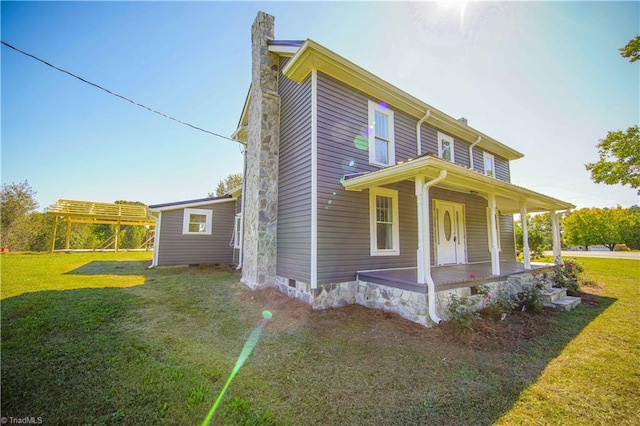 view of property exterior featuring a lawn and a porch