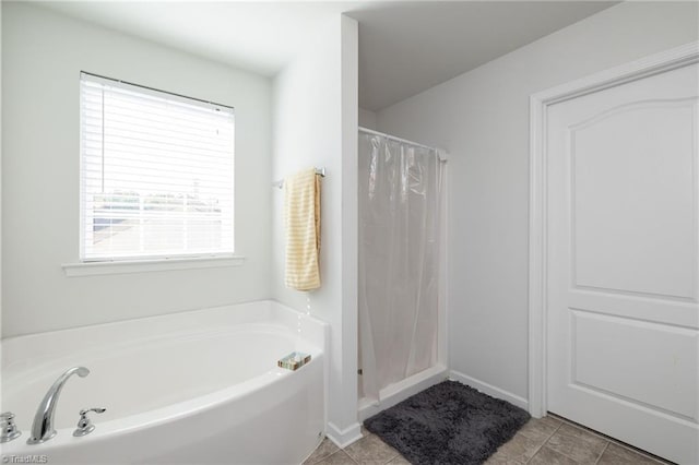 bathroom featuring tile patterned floors, a wealth of natural light, and plus walk in shower