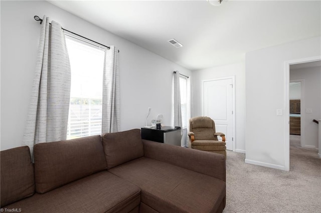 living room featuring light colored carpet and plenty of natural light