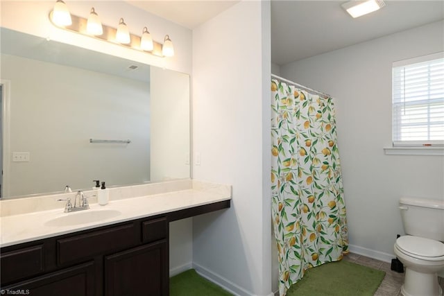 bathroom featuring tile patterned flooring, vanity, and toilet