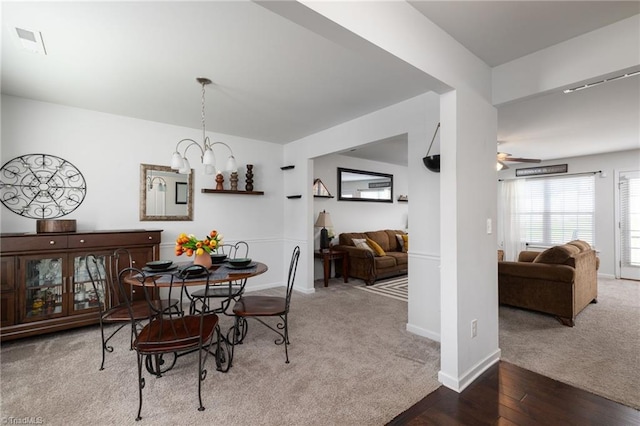 dining room featuring hardwood / wood-style floors and ceiling fan with notable chandelier