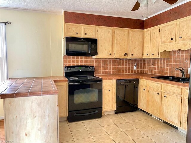 kitchen featuring black appliances, sink, decorative backsplash, a textured ceiling, and tile counters