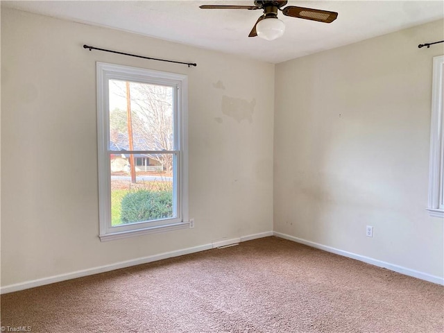 carpeted empty room featuring ceiling fan