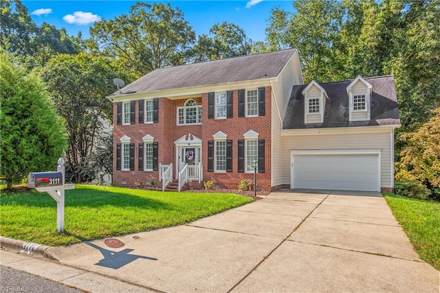 colonial home featuring a garage and a front yard