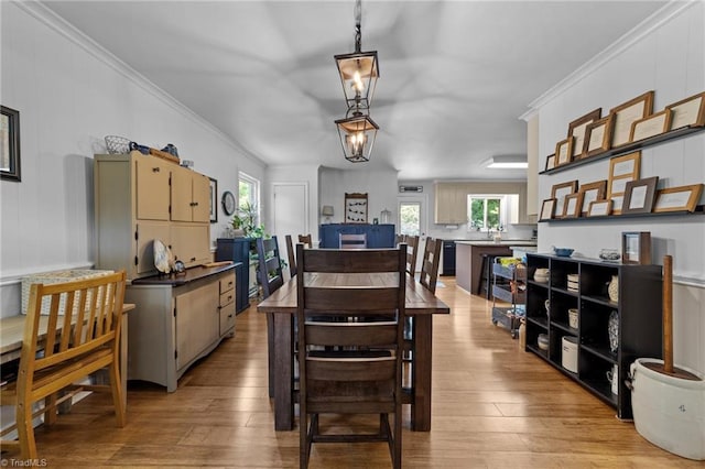 1805 Guilford College Rd, Jamestown, NC 27282 - dining area featuring light wood-style floors and ornamental molding
