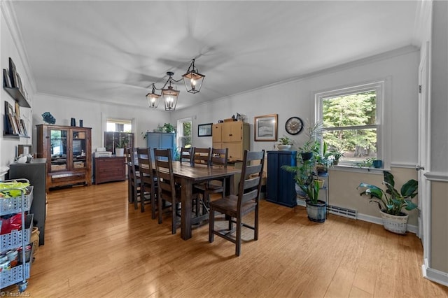 1805 Guilford College Rd, Jamestown, NC 27282 - dining space featuring light wood finished floors, ornamental molding, and a chandelier