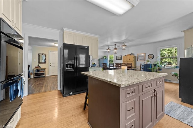 1805 Guilford College Rd, Jamestown, NC 27282 - kitchen with black appliances, light wood-style flooring, and healthy amount of natural light