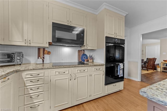 1805 Guilford College Rd, Jamestown, NC 27282 - kitchen featuring black appliances, light wood-style flooring, light stone countertops, and ornamental molding