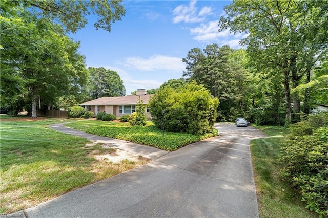 1805 Guilford College Rd, Jamestown, NC 27282 - view of front of property featuring driveway, a front lawn, and a chimney