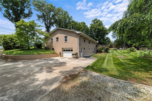 1805 Guilford College Rd, Jamestown, NC 27282 - view of home's exterior featuring concrete driveway, an attached garage, and a yard